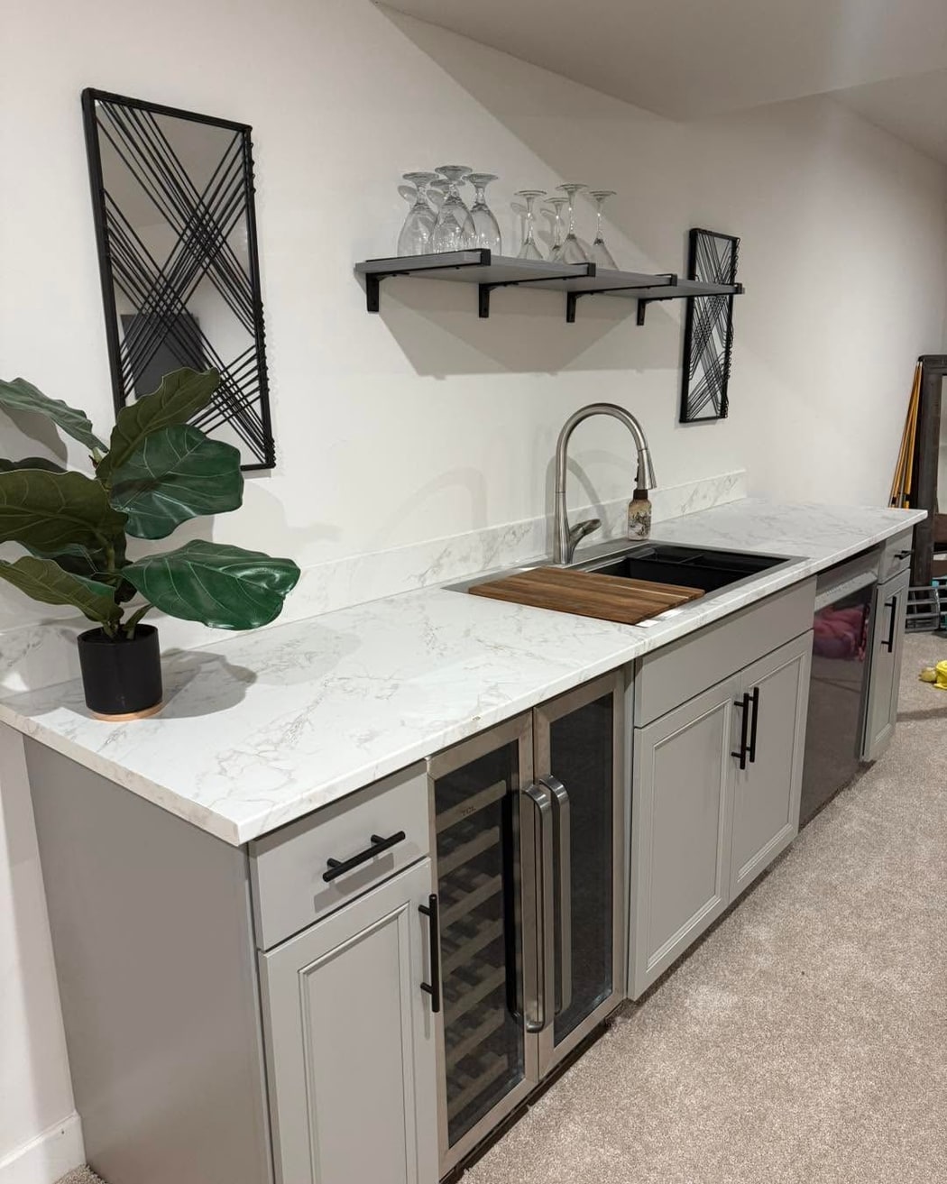 Basement wet bar with quartz countertop, wine fridge, and floating shelves, a Renewed Construction craftsmanship project